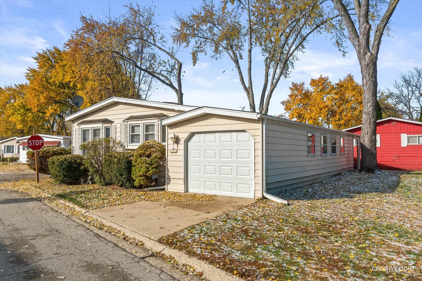 1122 Candida Road Elgin, IL 60123 - Photo 16 of 16 a front view of a house with a yard and garage