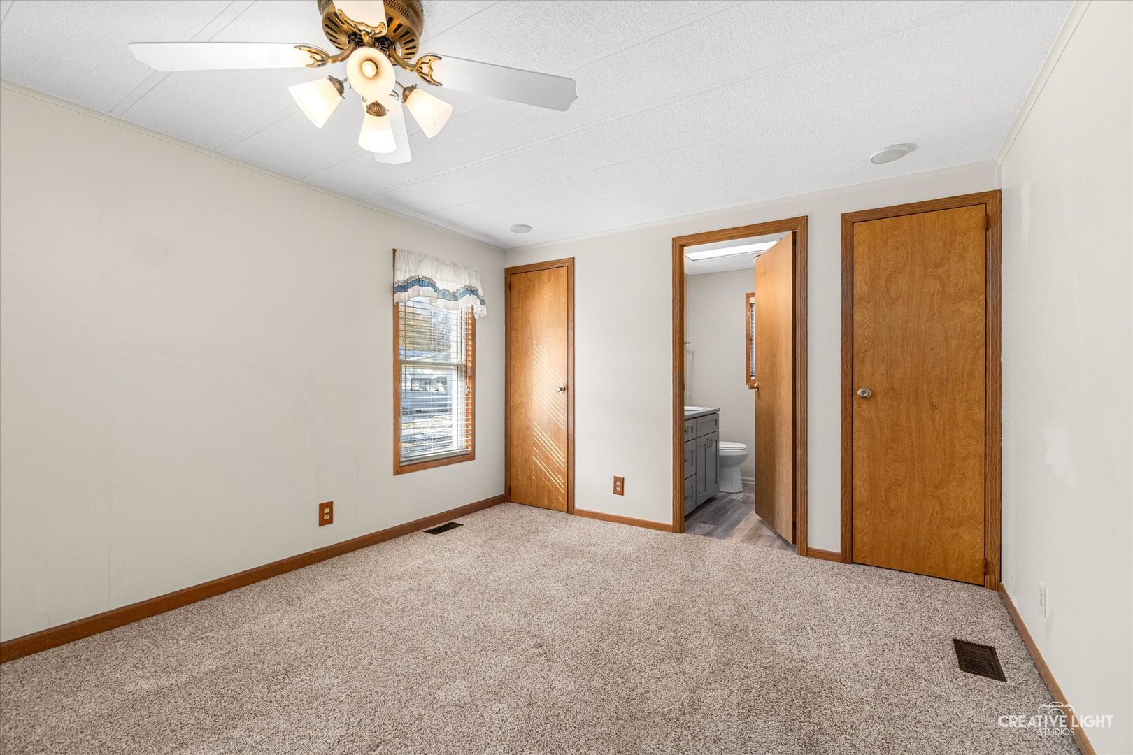 1122 Candida Road Elgin, IL 60123 - Photo 8 of 16 an empty room with windows and fan