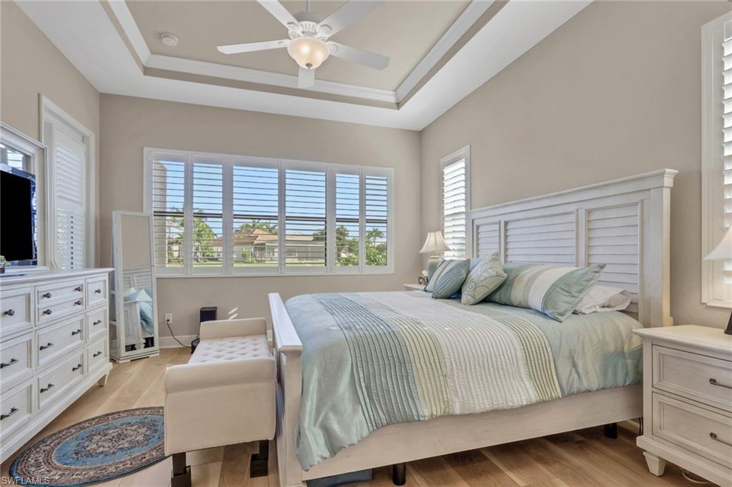 1589 Serrano Circle Naples, FL 34105 - Photo 13 of 38 a bedroom with a bed a dresser and next to a window