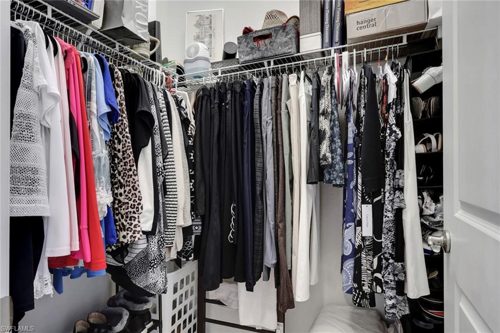 1589 Serrano Circle Naples, FL 34105 - Photo 19 of 38 a view of walk in closet with clothes