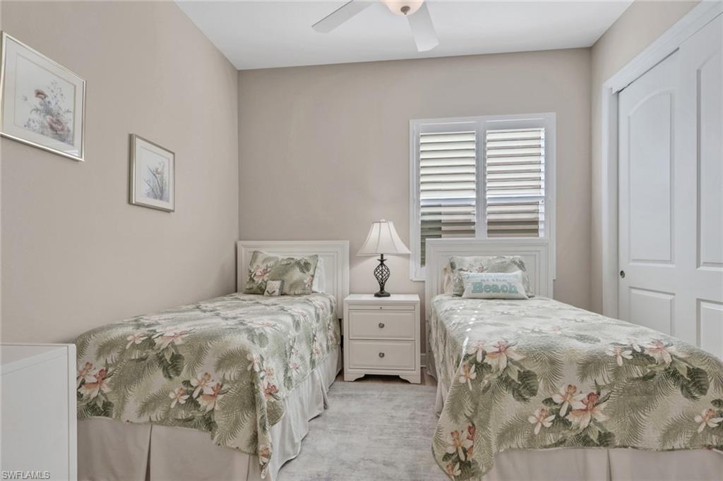 1589 Serrano Circle Naples, FL 34105 - Photo 20 of 38 a bedroom with a bed and a window