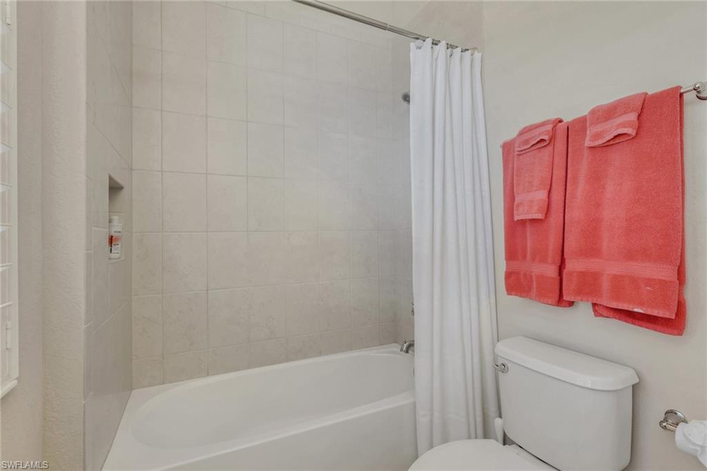 1589 Serrano Circle Naples, FL 34105 - Photo 26 of 38 a bathroom with a bathtub shower sink and toilet