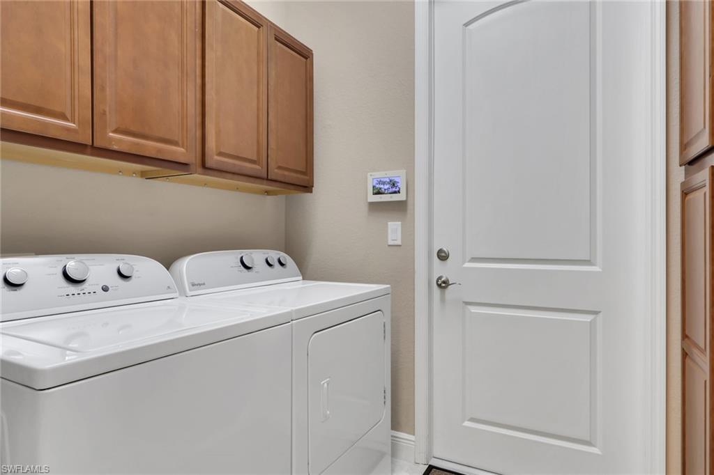 1589 Serrano Circle Naples, FL 34105 - Photo 27 of 38 a utility room with dryer and washer