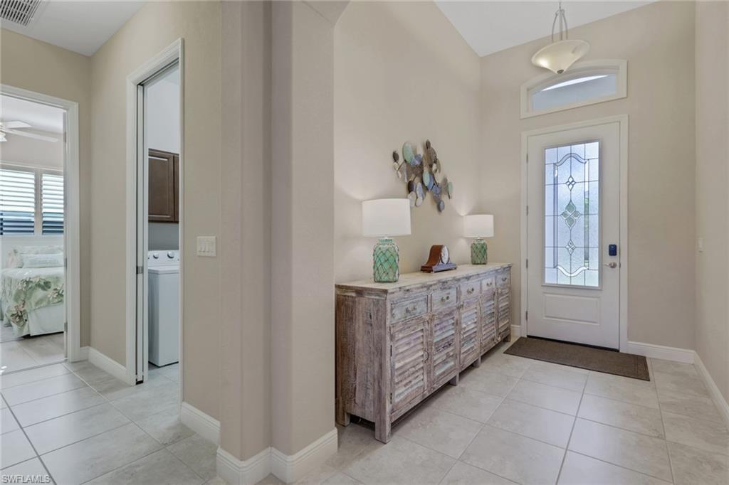 1589 Serrano Circle Naples, FL 34105 - Photo 3 of 38 a living room with furniture and a wooden floor