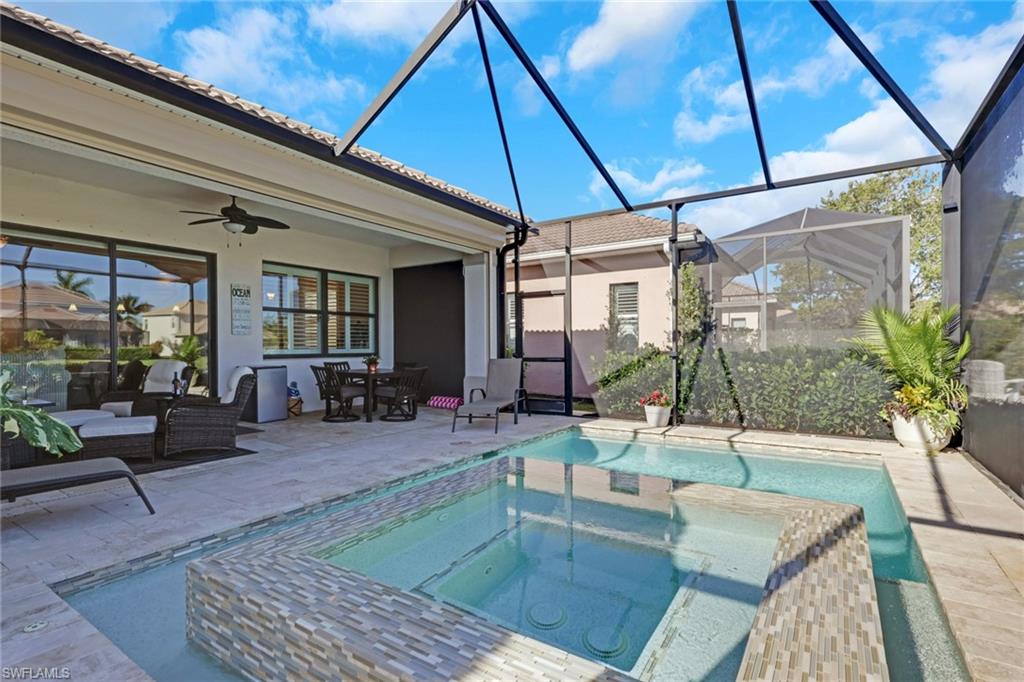 1589 Serrano Circle Naples, FL 34105 - Photo 31 of 38 a indoor swimming pool with outdoor seating