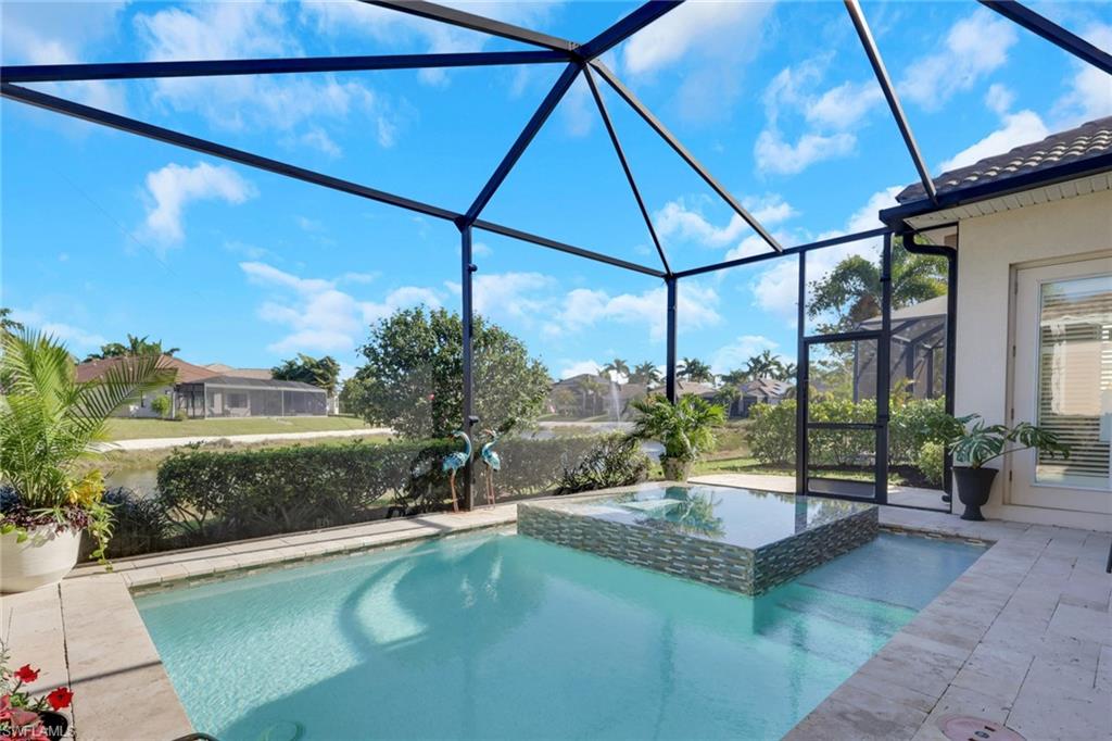 1589 Serrano Circle Naples, FL 34105 - Photo 32 of 38 a view of a swimming pool with a patio