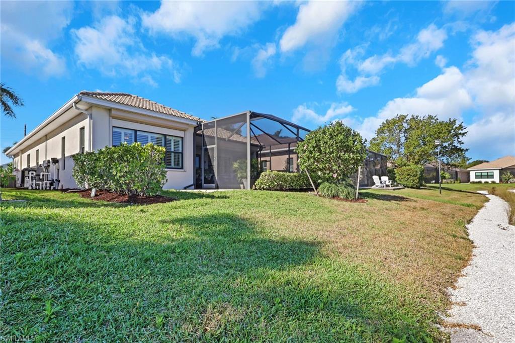 1589 Serrano Circle Naples, FL 34105 - Photo 34 of 38 a front view of a house with garden