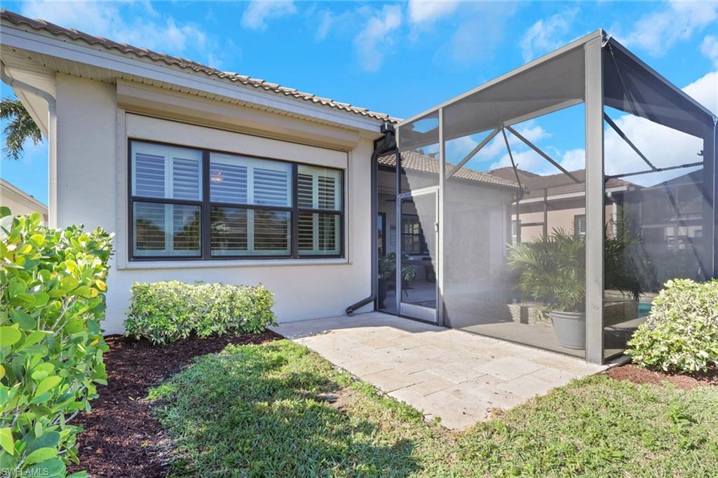 1589 Serrano Circle Naples, FL 34105 - Photo 35 of 38 a front view of a house with a garden