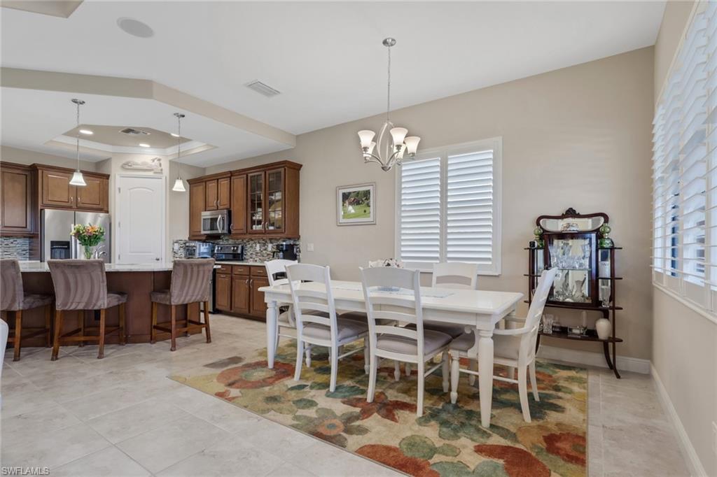 1589 Serrano Circle Naples, FL 34105 - Photo 8 of 38 a view of a dining room with furniture