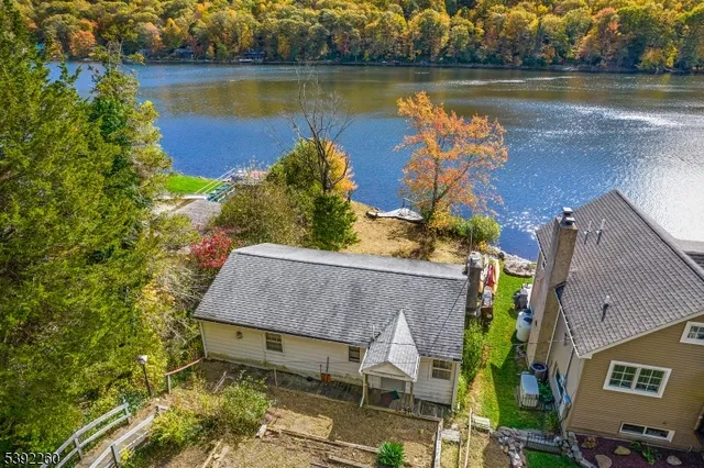 an aerial view of a house with a lake view