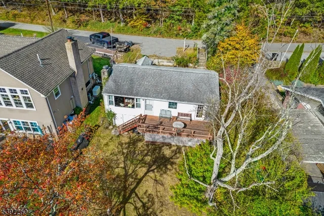 a aerial view of a house with swimming pool and large trees
