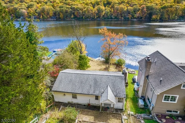 an aerial view of house with yard and lake view