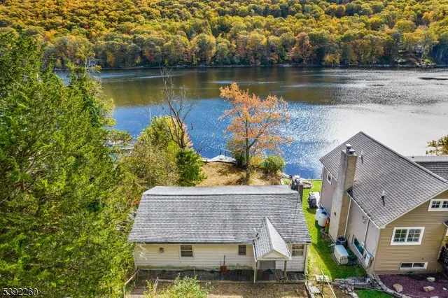 an aerial view of a house with a lake view
