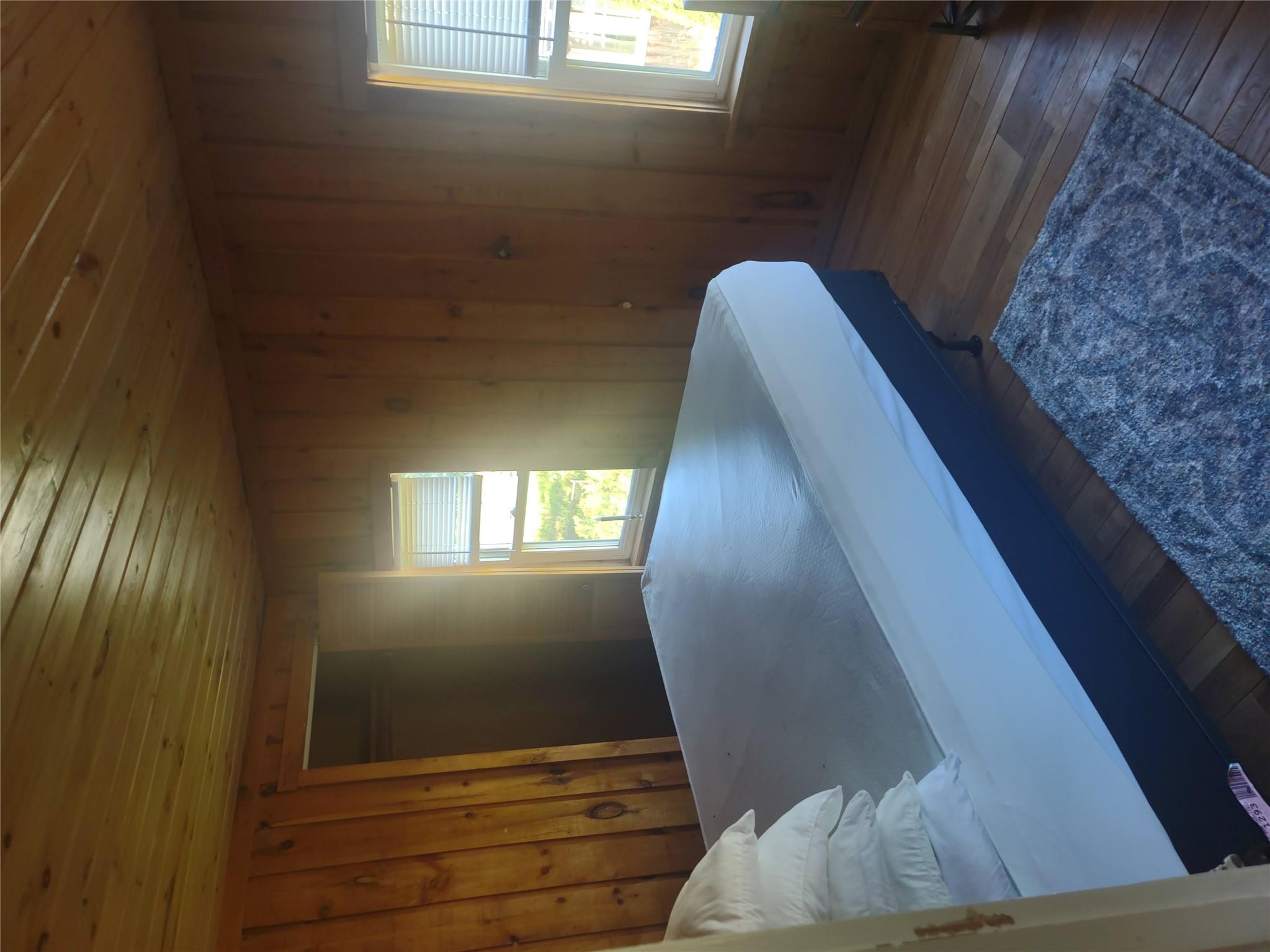 1139 State Rt 17B Mongaup Valley, NY 12762 - Photo 23 of 35 Bedroom featuring wood ceiling, hardwood / wood-style floors, and wood walls