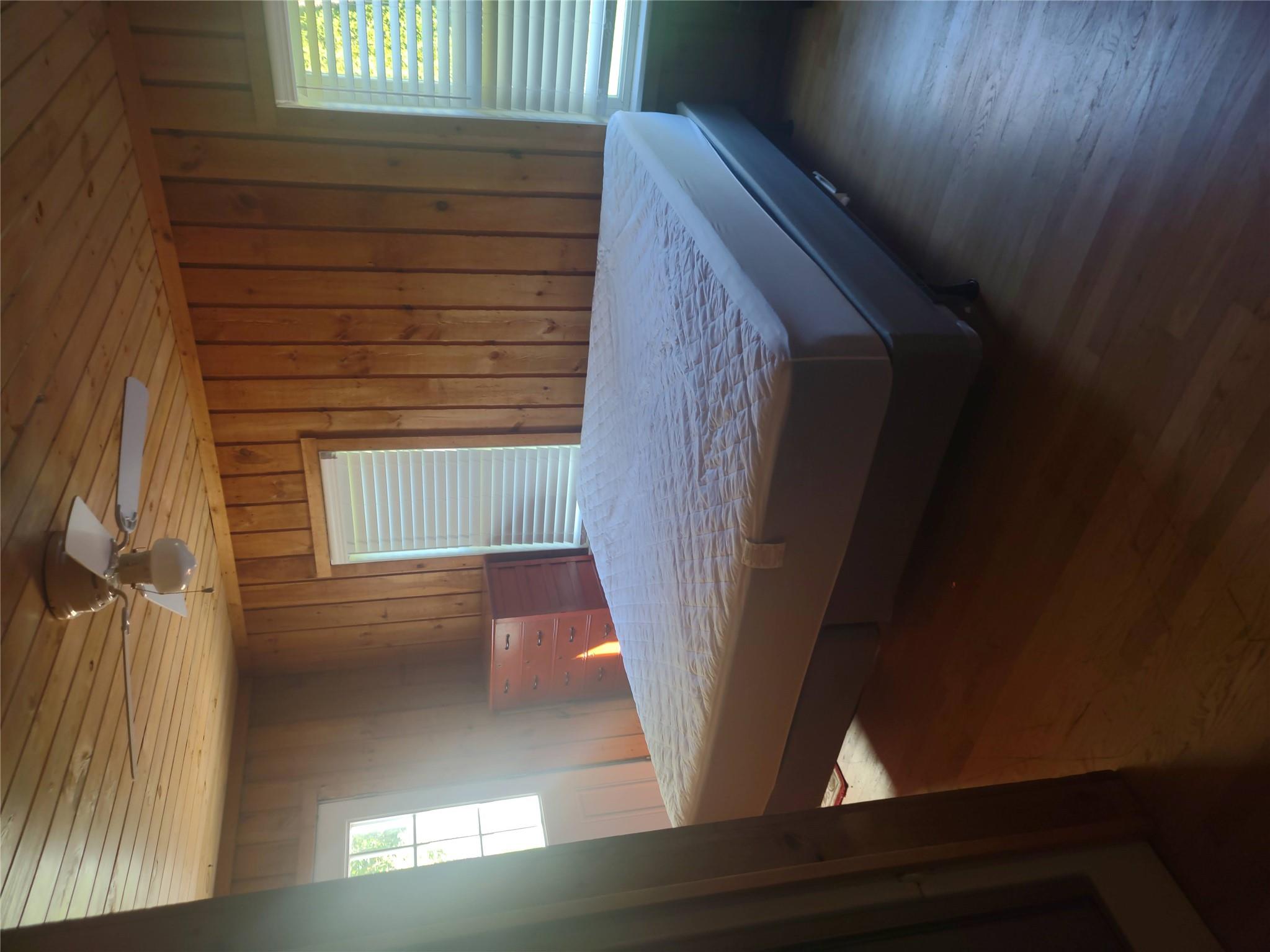 1139 State Rt 17B Mongaup Valley, NY 12762 - Photo 30 of 35 Bedroom with wooden ceiling, wood finished floors, and wood walls