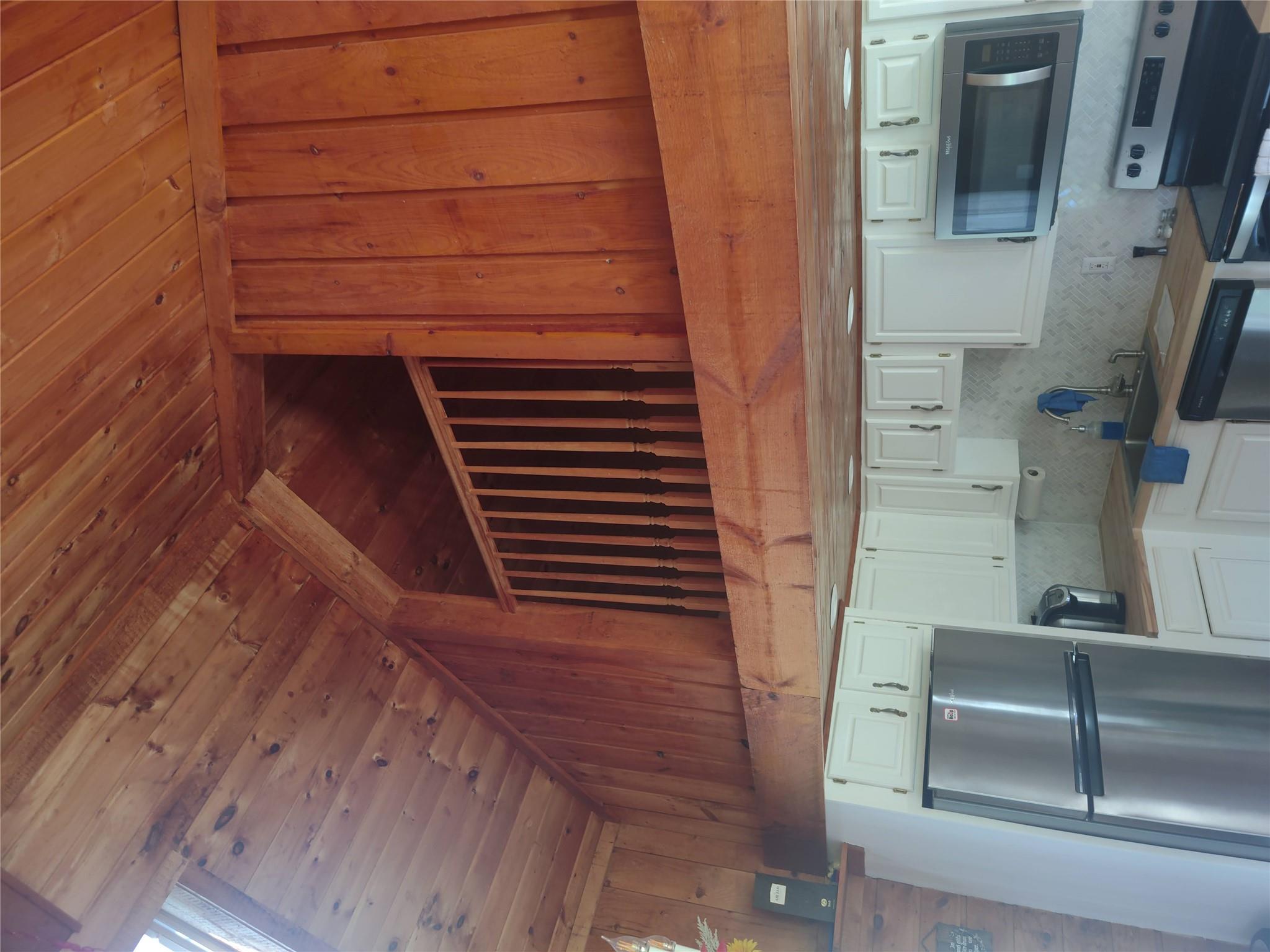 1139 State Rt 17B Mongaup Valley, NY 12762 - Photo 31 of 35 Kitchen featuring range, refrigerator, wood ceiling, dishwashing machine, and wood walls