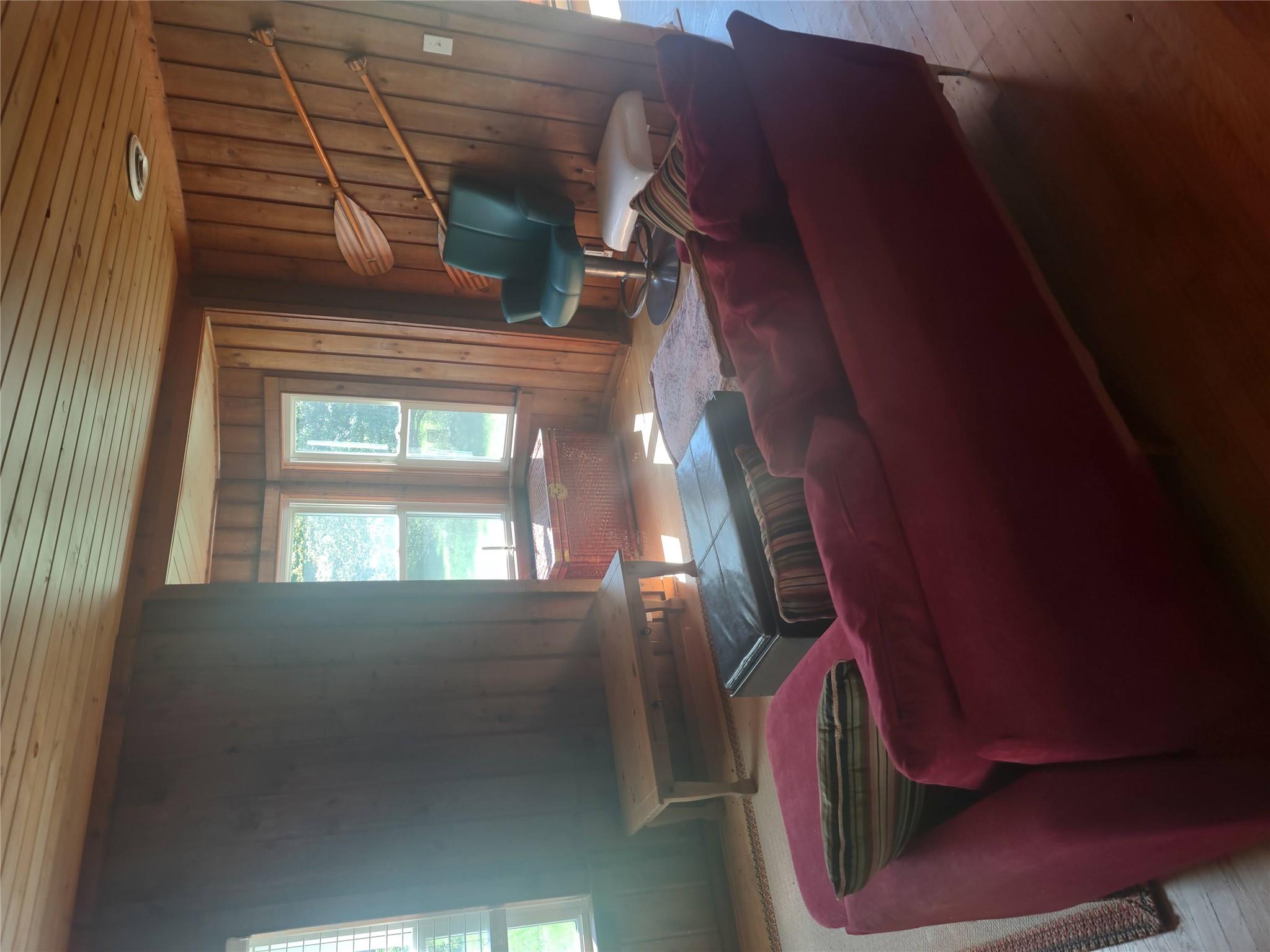 1139 State Rt 17B Mongaup Valley, NY 12762 - Photo 5 of 35 Living room featuring wood walls, wooden ceiling, and wood finished floors