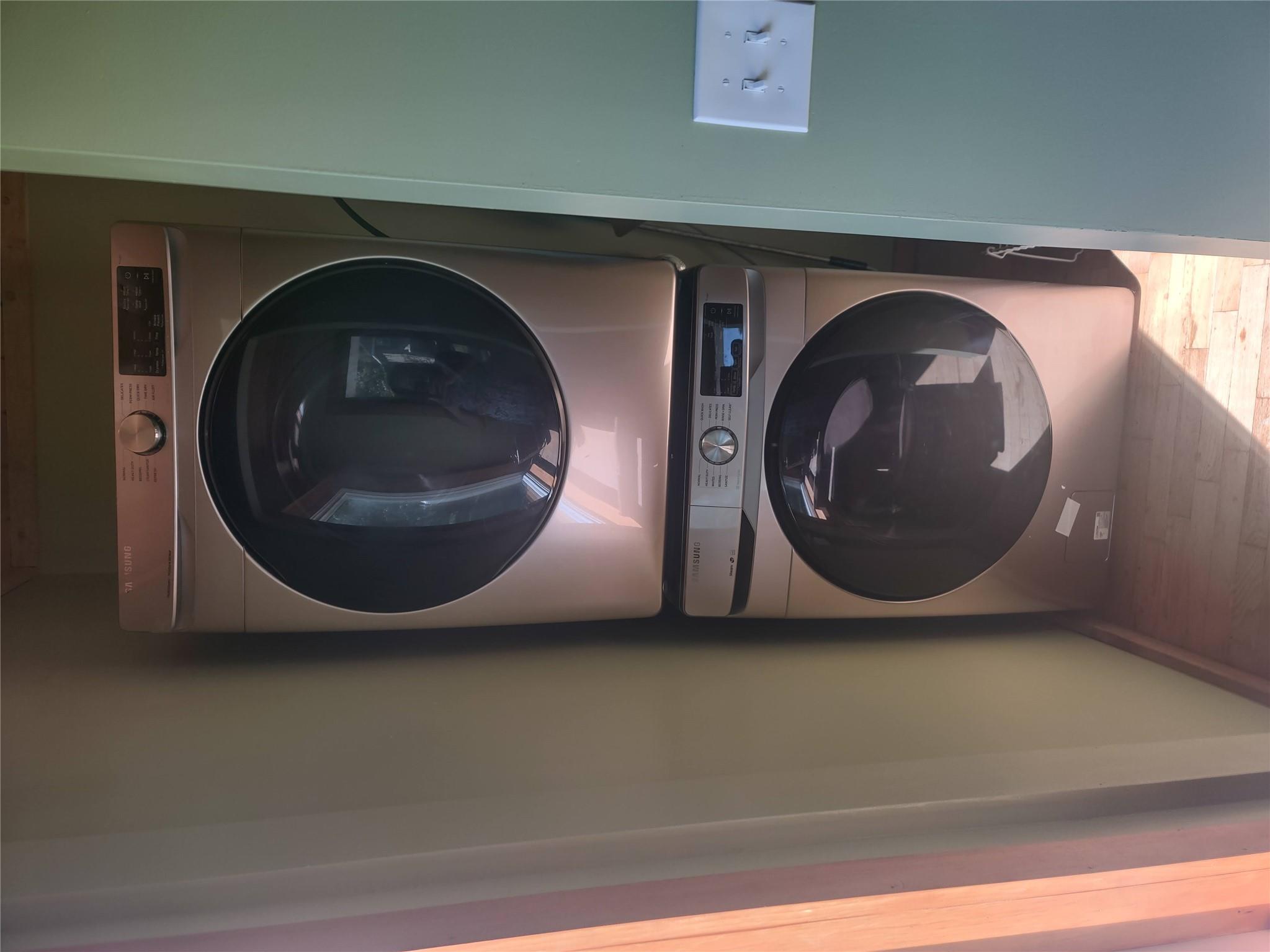 1139 State Rt 17B Mongaup Valley, NY 12762 - Photo 9 of 35 Laundry area with stacked washer / drying machine and wood finished floors