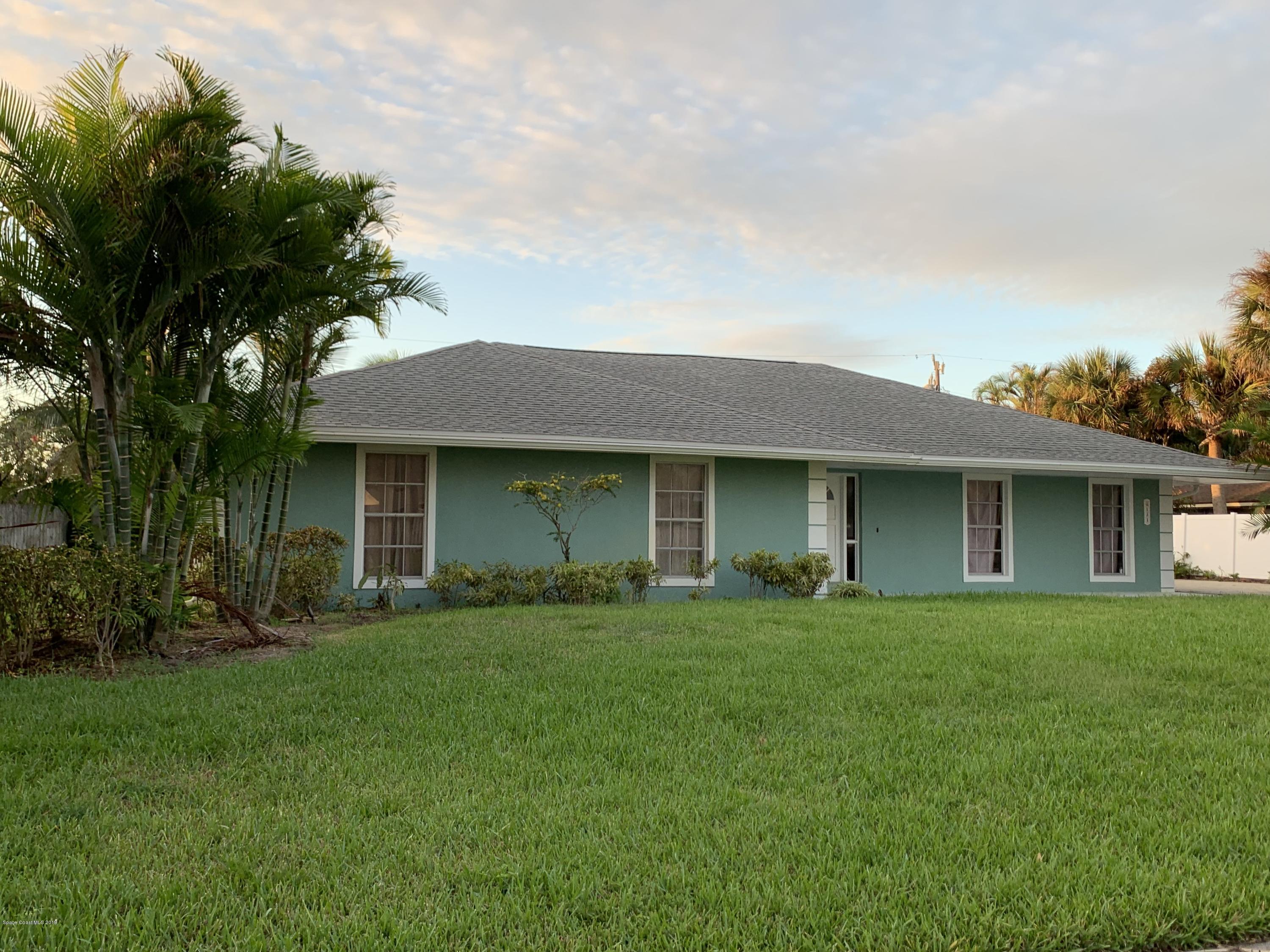 131 13th Avenue Indialantic, FL 32903 - Photo 1 of 23 a front view of a house with a yard and trees