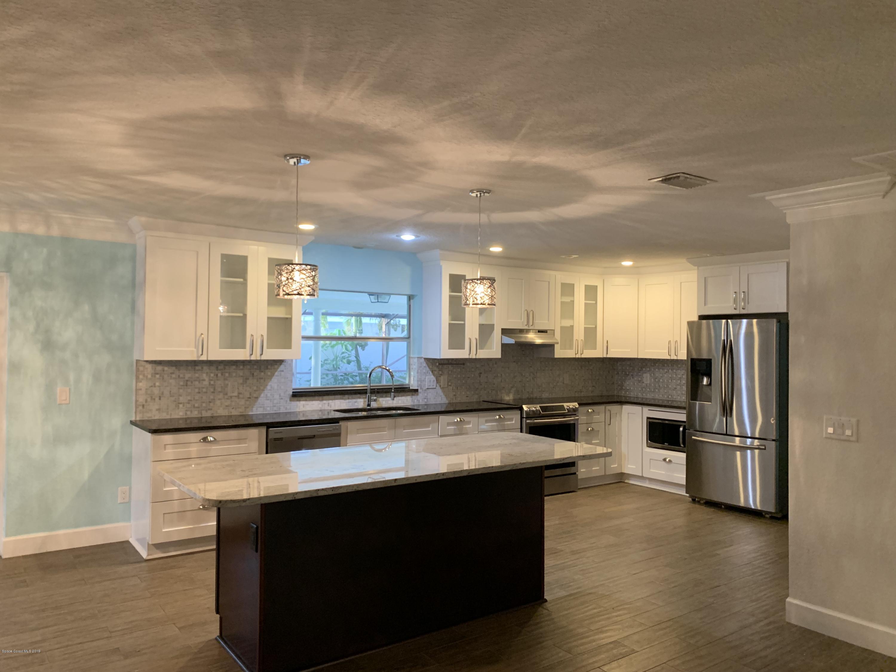 131 13th Avenue Indialantic, FL 32903 - Photo 2 of 23 a kitchen with stainless steel appliances granite countertop a sink stove and refrigerator