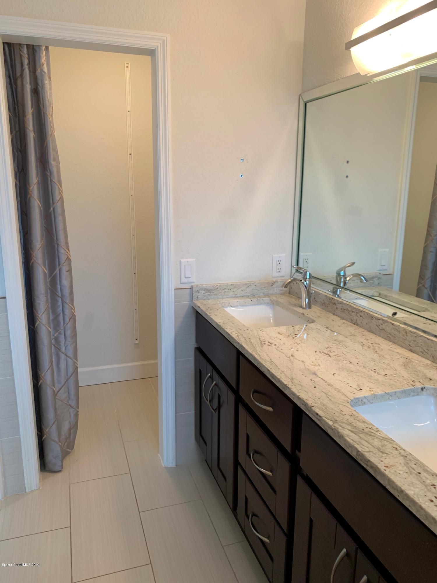 131 13th Avenue Indialantic, FL 32903 - Photo 17 of 23 a bathroom with a granite countertop sink and a mirror
