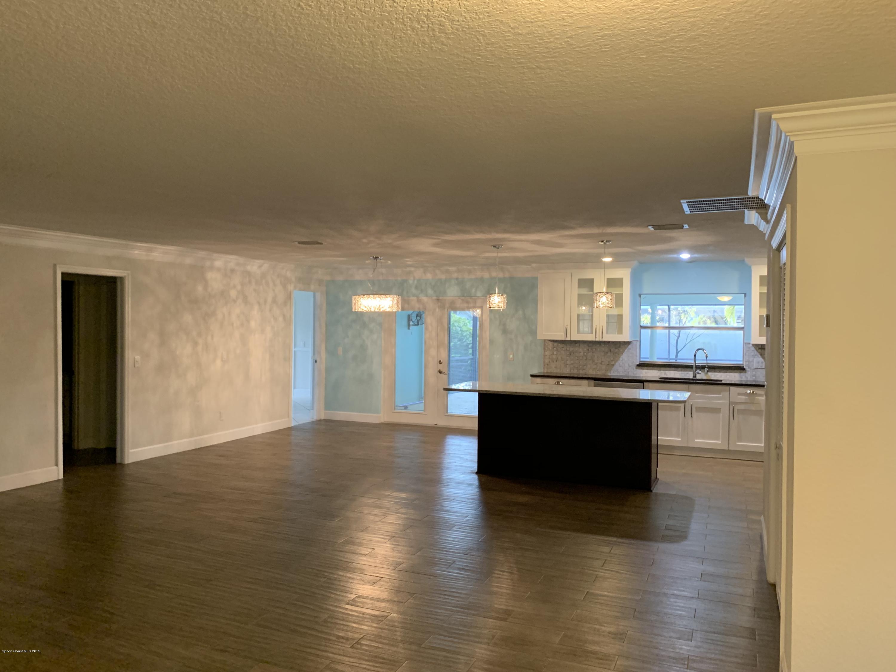 131 13th Avenue Indialantic, FL 32903 - Photo 3 of 23 a view of kitchen and dining room with wooden floor