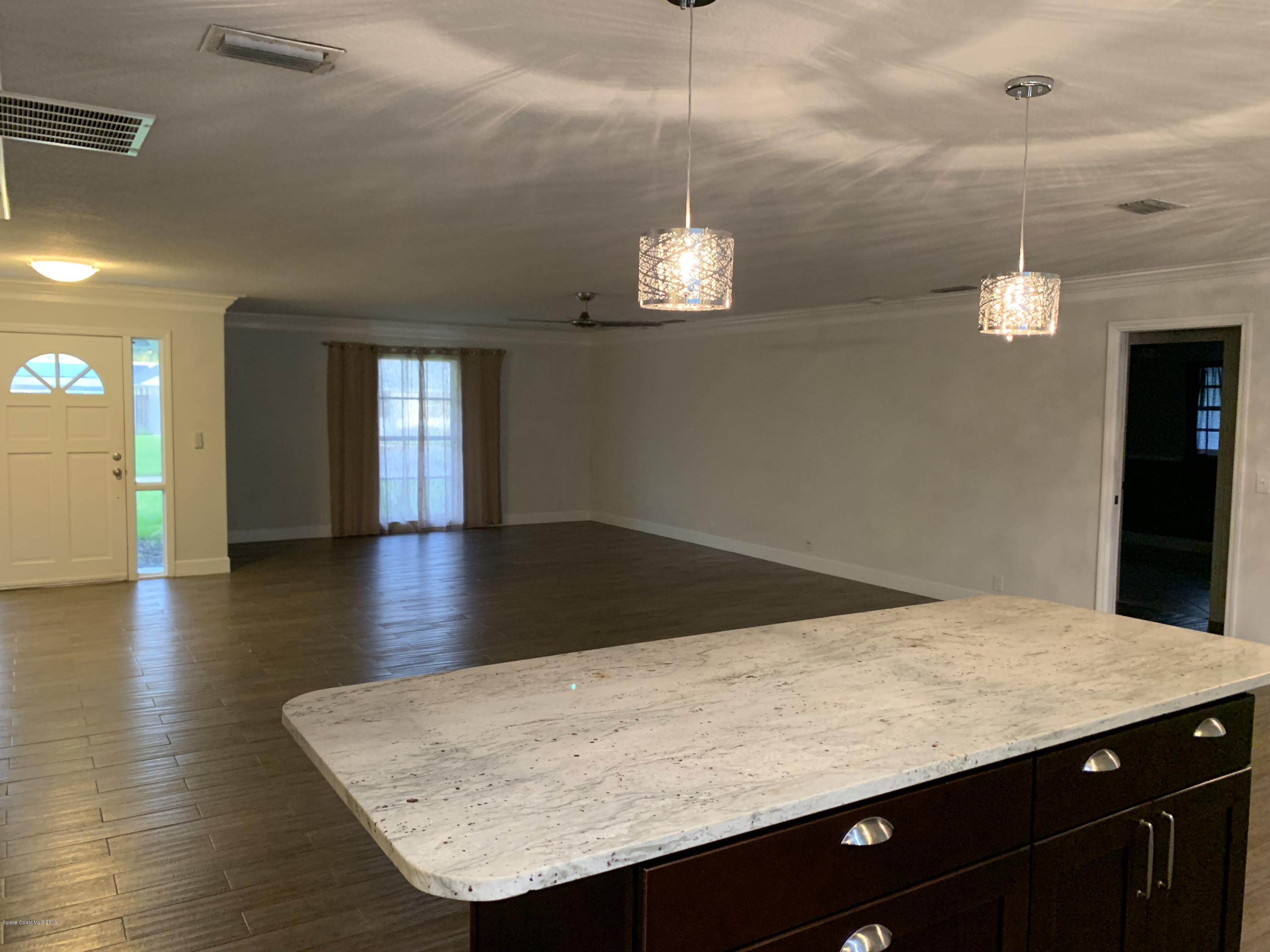 131 13th Avenue Indialantic, FL 32903 - Photo 4 of 23 a view of kitchen and hall with wooden floor