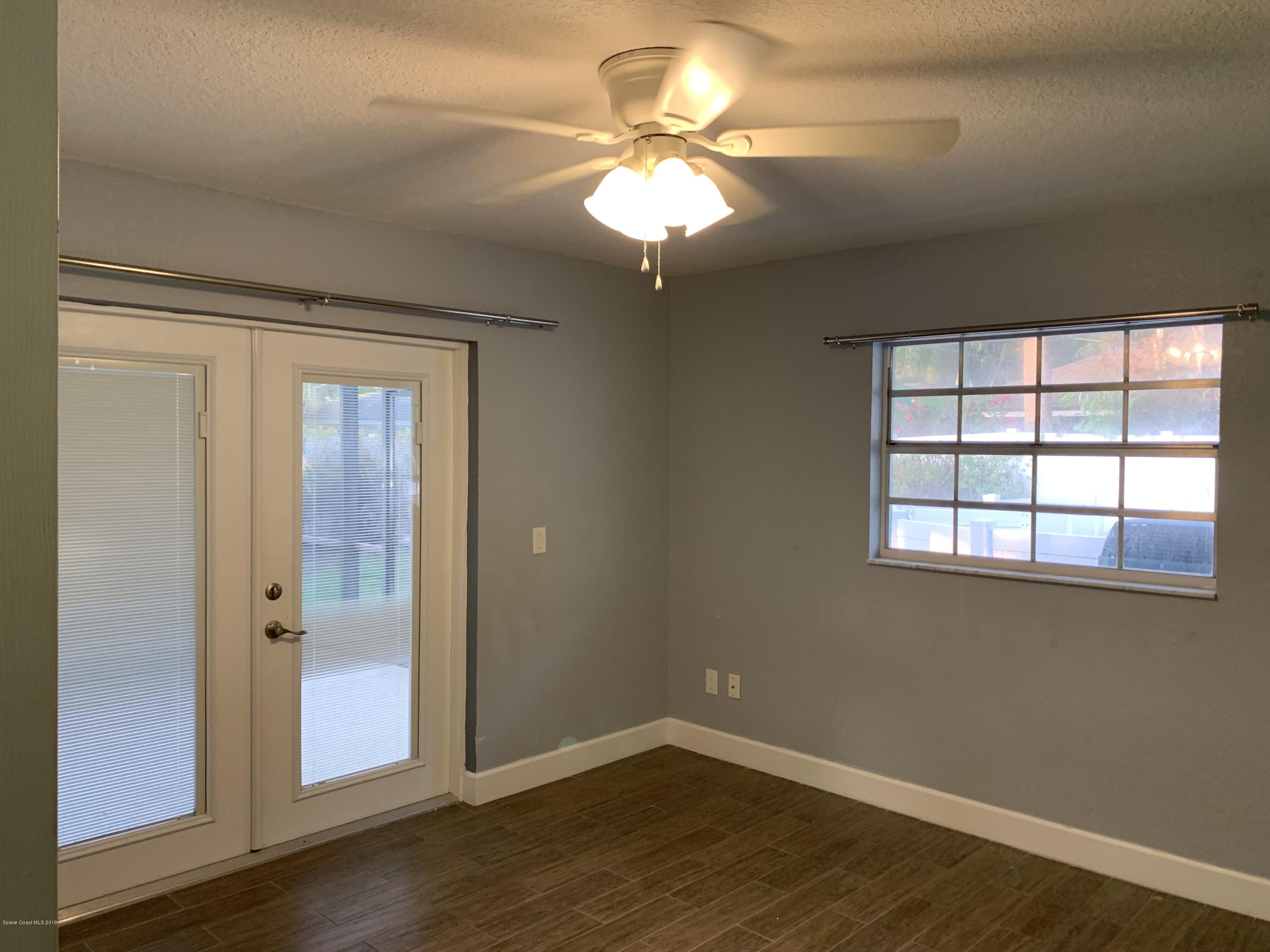 131 13th Avenue Indialantic, FL 32903 - Photo 6 of 23 wooden floor in an empty room with a window
