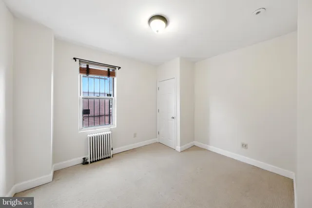 an empty room with windows and closet