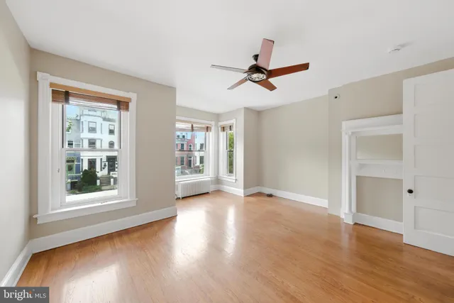 a view of room with hardwood floor and windows