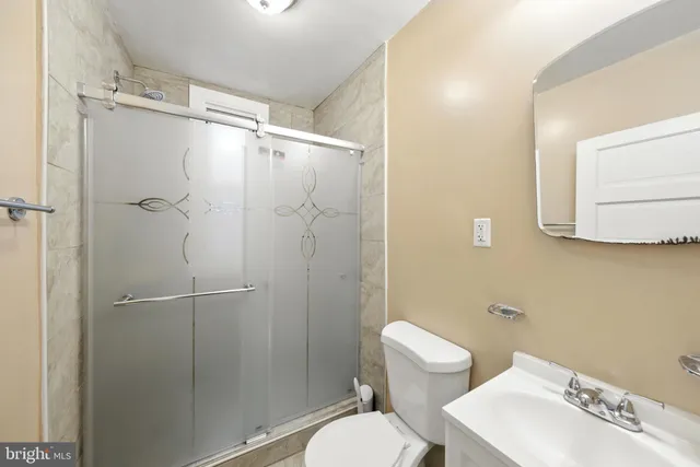 a bathroom with a toilet a sink and shower