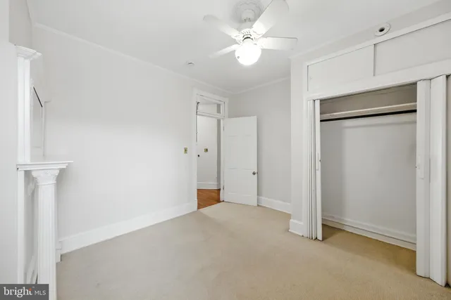 a view of an empty room with a fan
