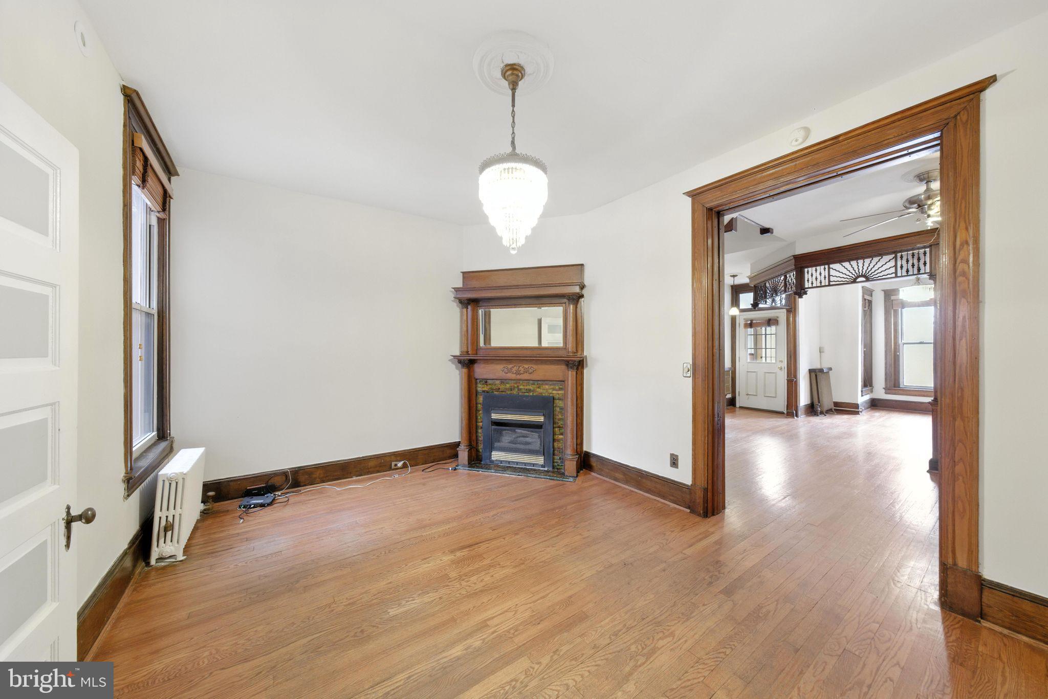 1763 U Street Northwest Washington, DC 20009 - Photo 6 of 28 a view of a livingroom with wooden floor and a ceiling fan