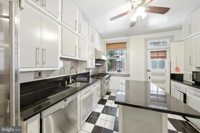 a kitchen with stainless steel appliances granite countertop a sink and cabinets
