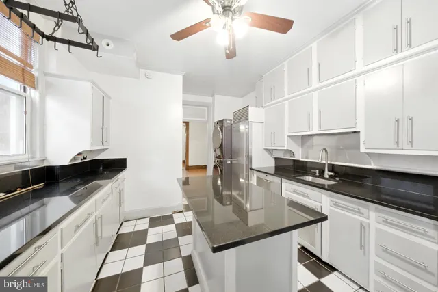 a kitchen with stainless steel appliances granite countertop a sink and cabinets