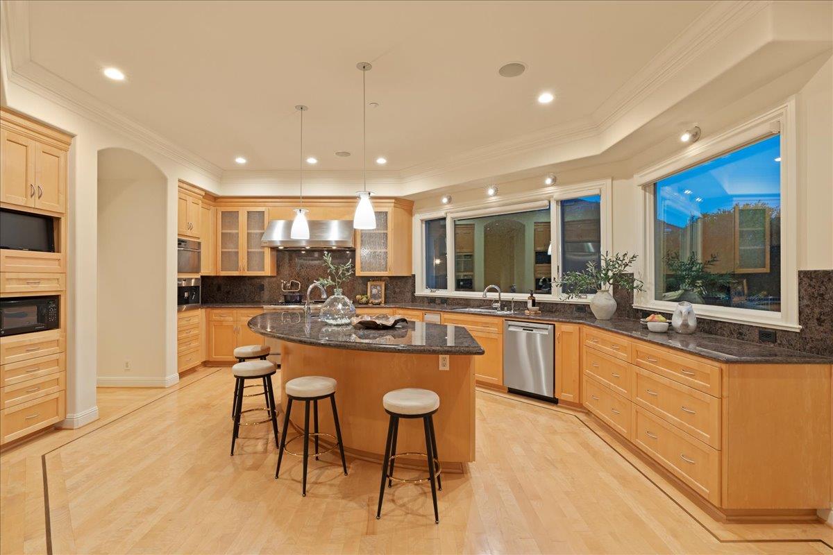8350 Verbena Drive Gilroy, CA 95020 - Photo 16 of 51 a kitchen with stainless steel appliances kitchen island granite countertop a sink and cabinets