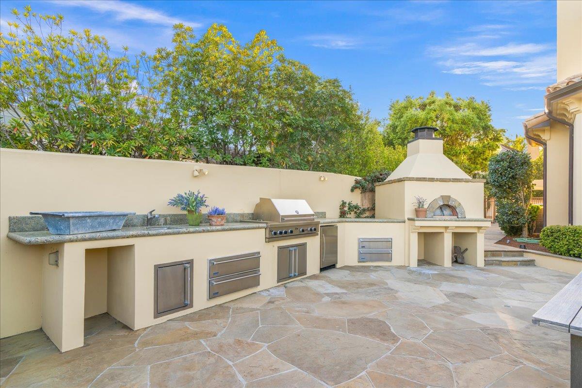 8350 Verbena Drive Gilroy, CA 95020 - Photo 41 of 51 a view of a white house with a yard and a fireplace