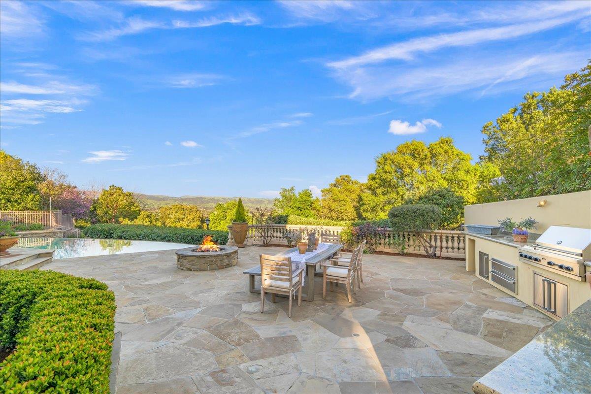 8350 Verbena Drive Gilroy, CA 95020 - Photo 43 of 51 a view of a patio with a table and chairs under an umbrella
