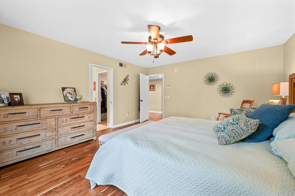 3625 Laketree Drive Fallbrook, CA 92028 - Photo 21 of 52 a bedroom with a bed and a chandelier