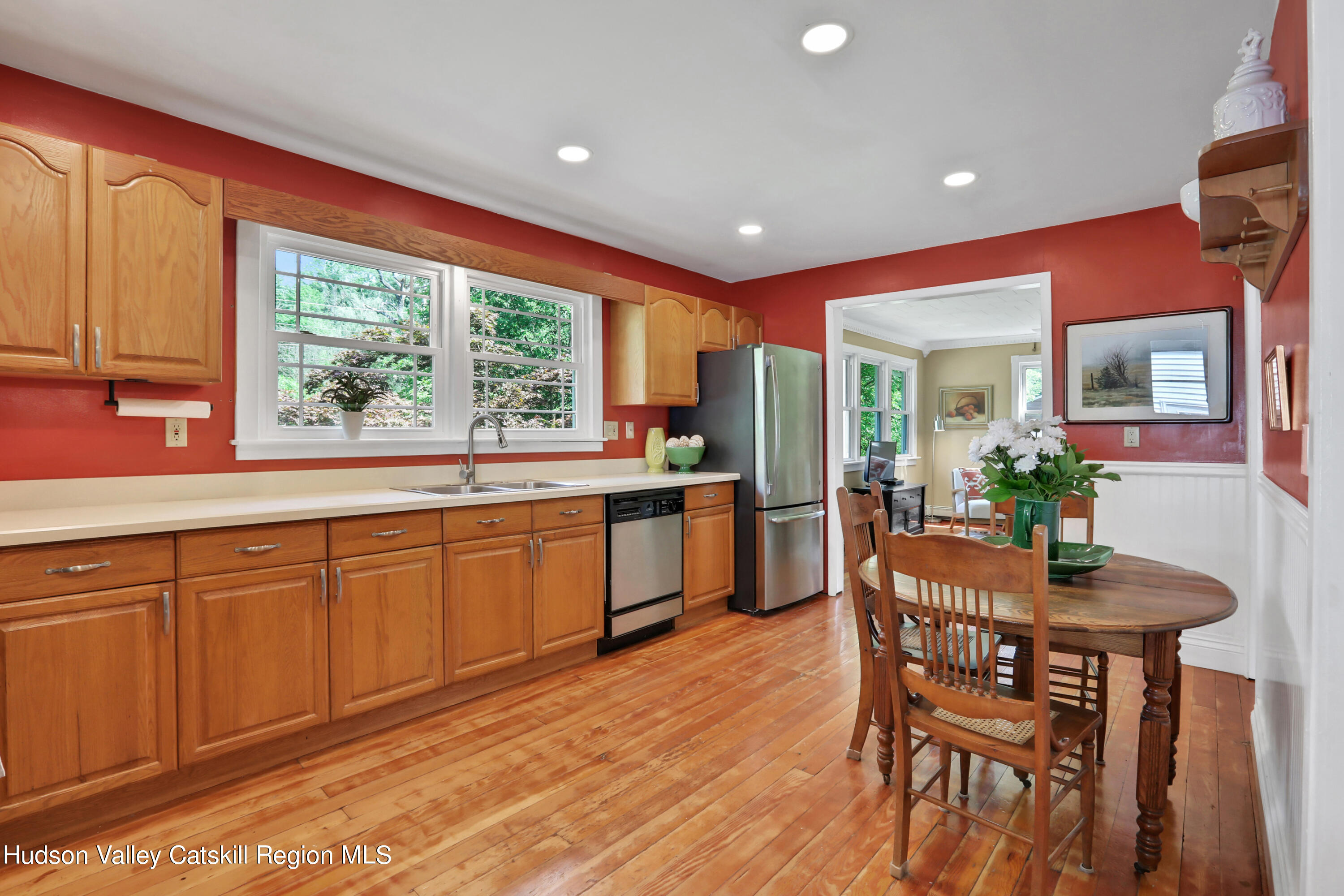 667 Albany Post Road New Paltz, NY 12561 - Photo 12 of 44 a kitchen with stainless steel appliances granite countertop wooden floor dining table and chairs