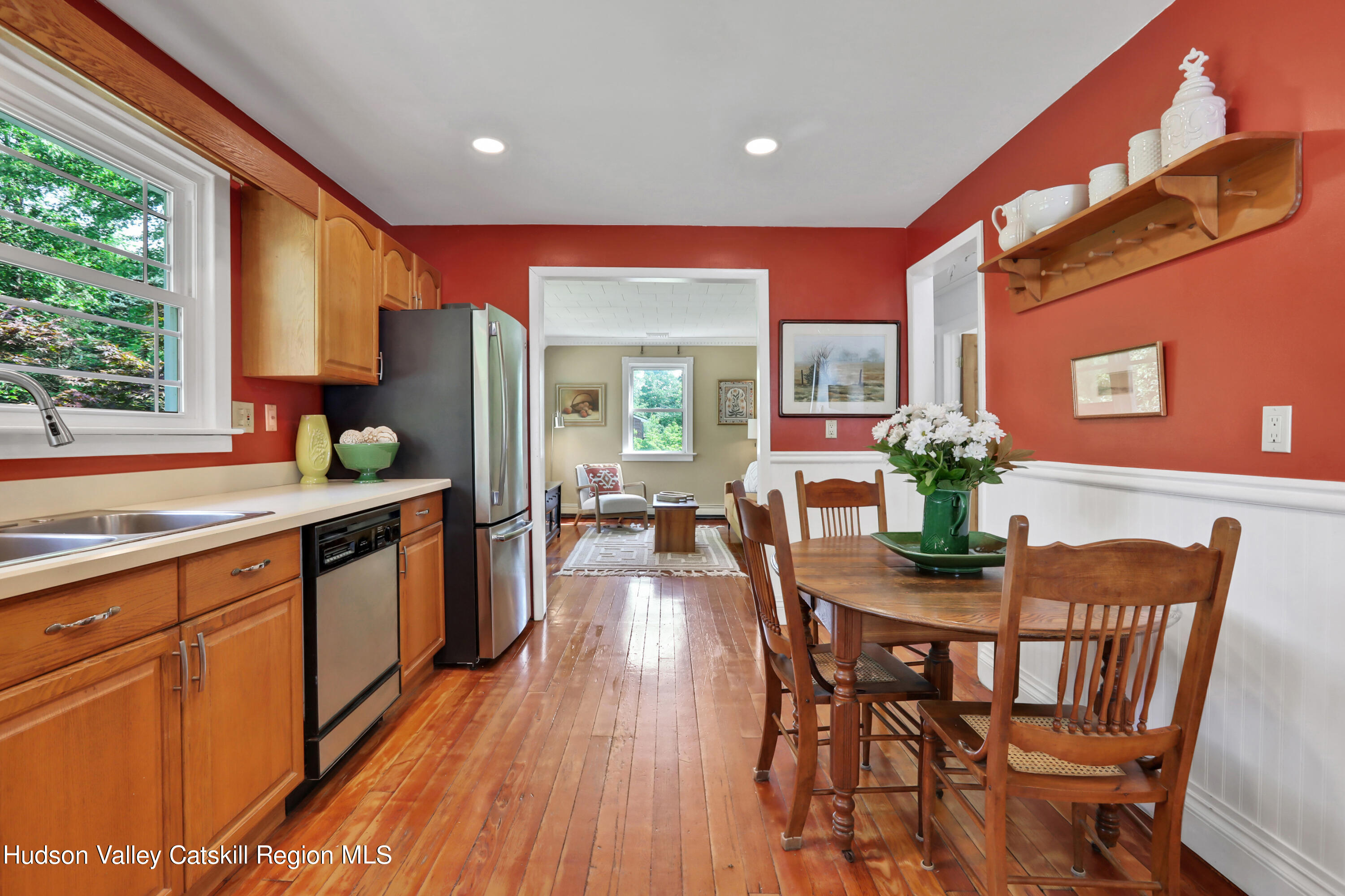 667 Albany Post Road New Paltz, NY 12561 - Photo 14 of 44 a kitchen with stainless steel appliances kitchen island granite countertop a dining table chairs and granite counter tops