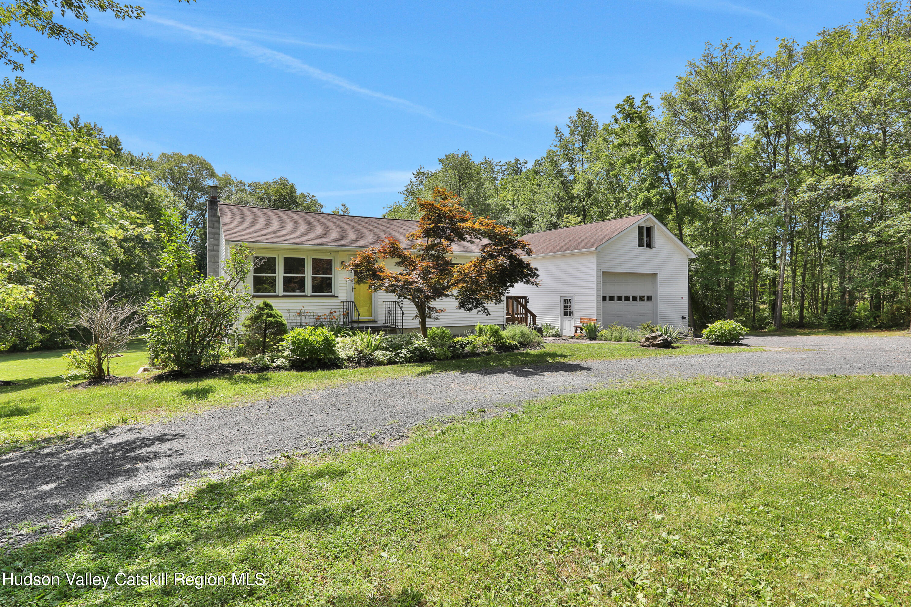 667 Albany Post Road New Paltz, NY 12561 - Photo 2 of 44 a front view of a house with a yard and trees