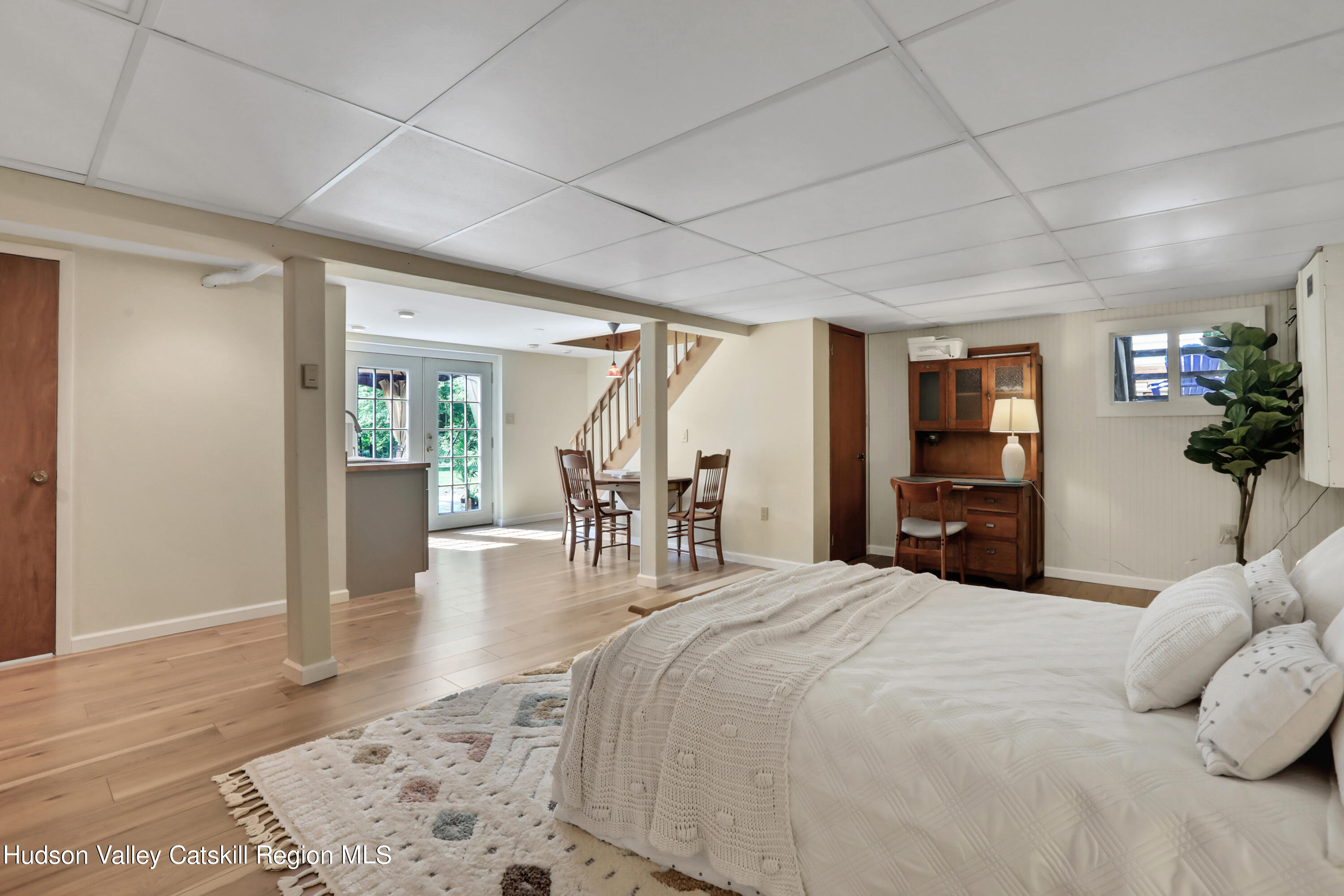 667 Albany Post Road New Paltz, NY 12561 - Photo 29 of 44 a large bedroom with a bed and wooden floor