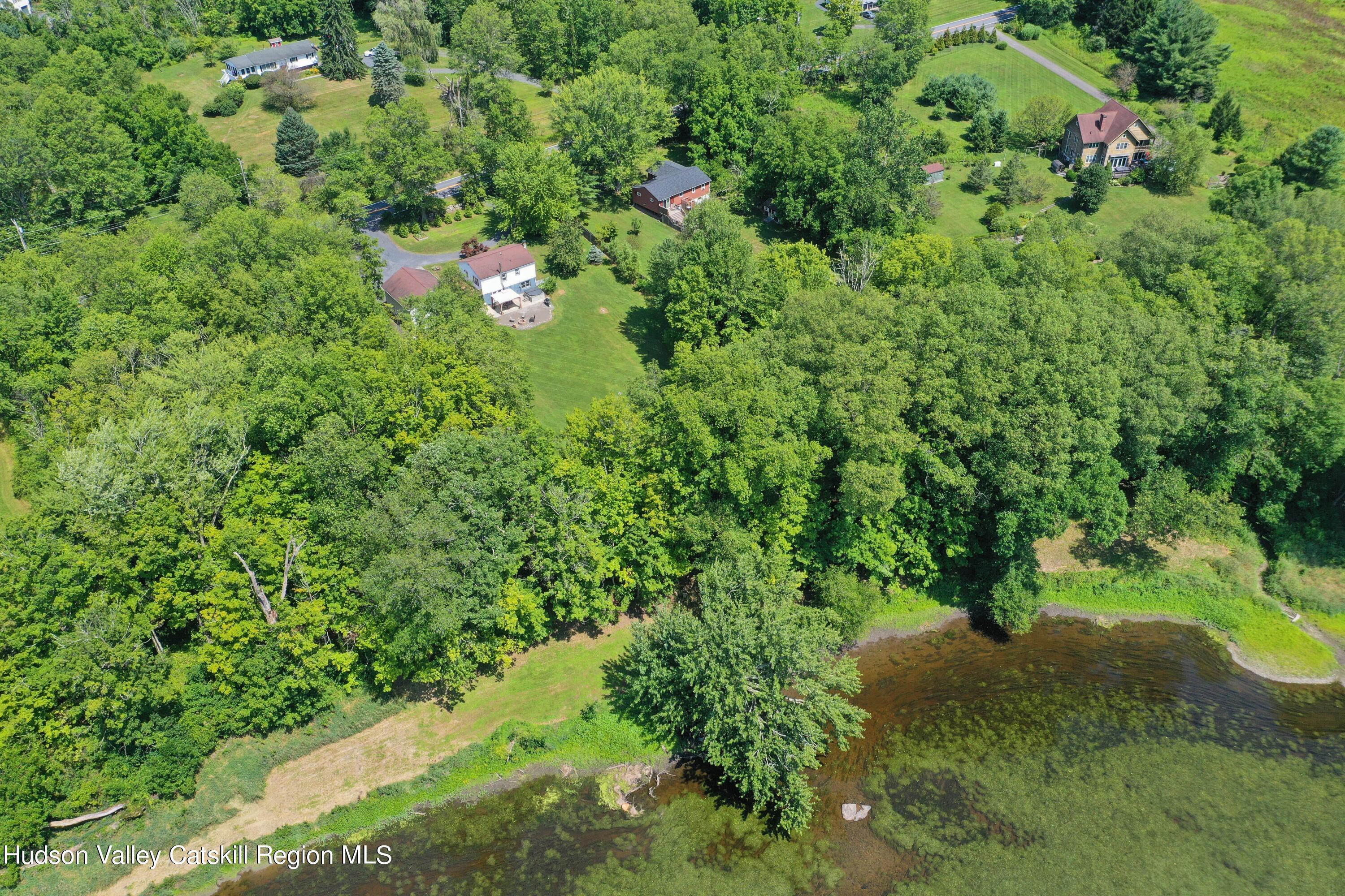 667 Albany Post Road New Paltz, NY 12561 - Photo 3 of 44 a backyard of a house with a yard and large trees
