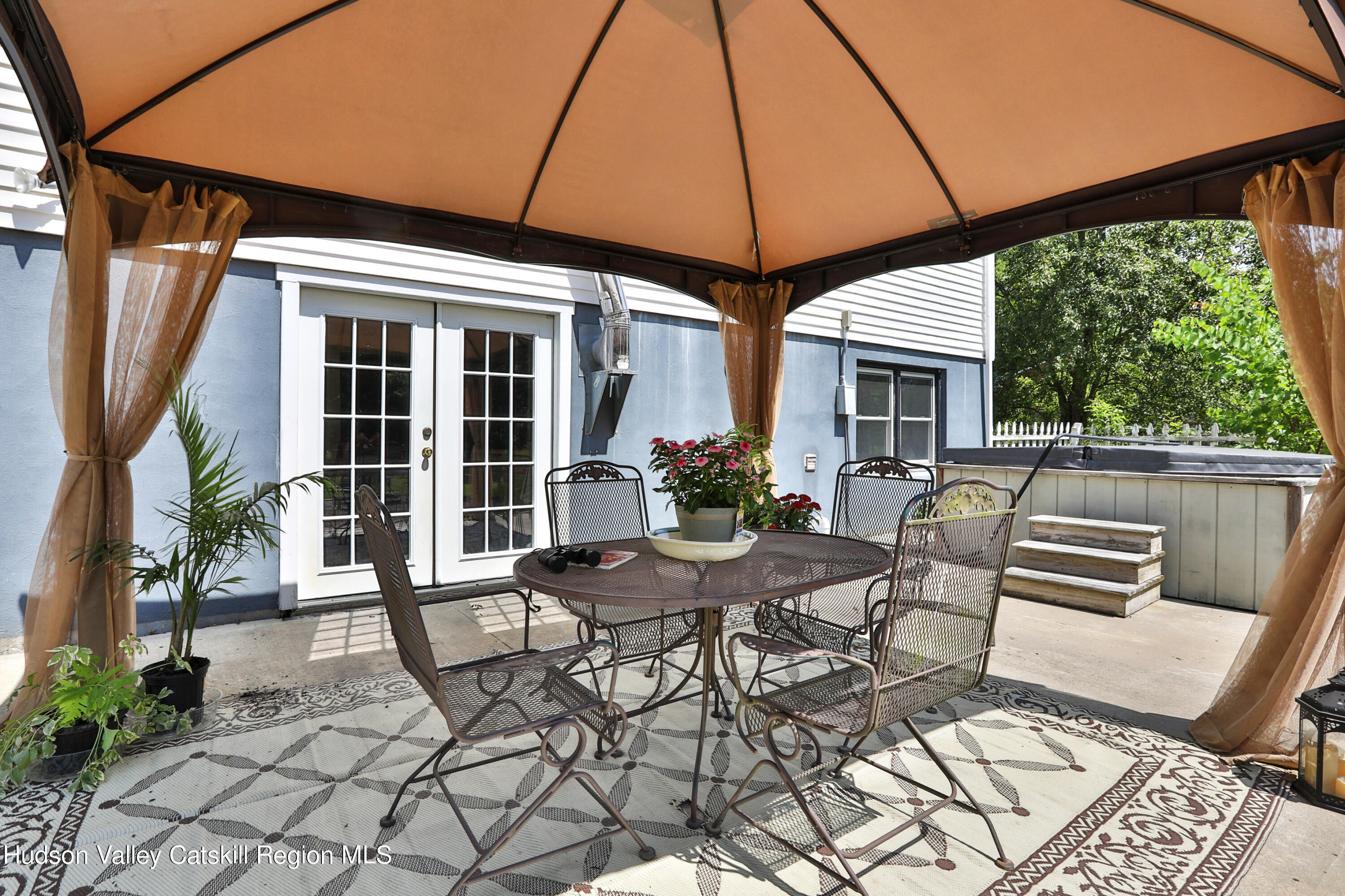 667 Albany Post Road New Paltz, NY 12561 - Photo 35 of 44 a view of a patio with a table and chairs under an umbrella