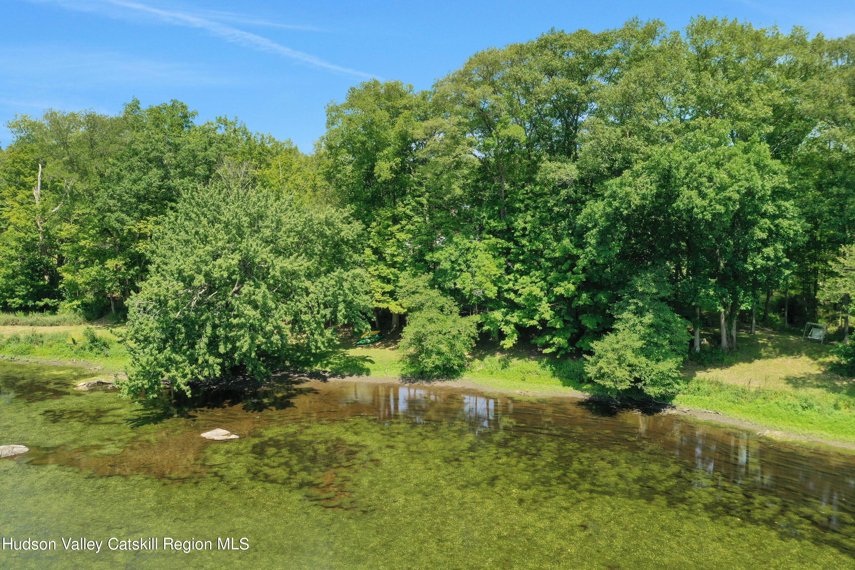 667 Albany Post Road New Paltz, NY 12561 - Photo 5 of 44 a view of a garden with a lake