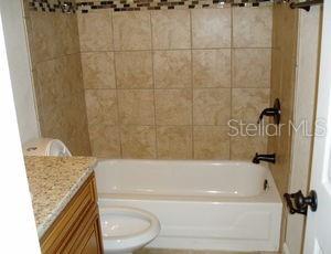3121 Vasco Street, Unit 2 Punta Gorda, FL 33950 - Photo 6 of 17 a bathroom with a granite countertop sink toilet and bathtub