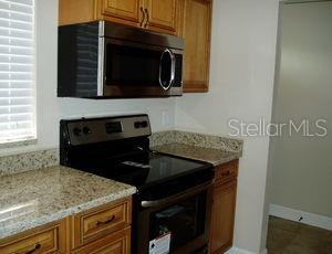 3121 Vasco Street, Unit 2 Punta Gorda, FL 33950 - Photo 7 of 17 a kitchen with a stove and a microwave