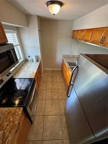 a kitchen with a sink and a refrigerator
