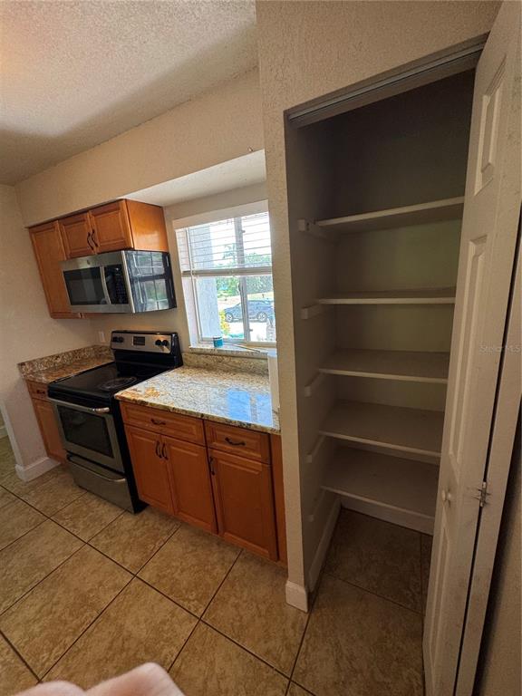 3121 Vasco Street, Unit 2 Punta Gorda, FL 33950 - Photo 10 of 17 a kitchen with granite countertop a stove and a cabinet